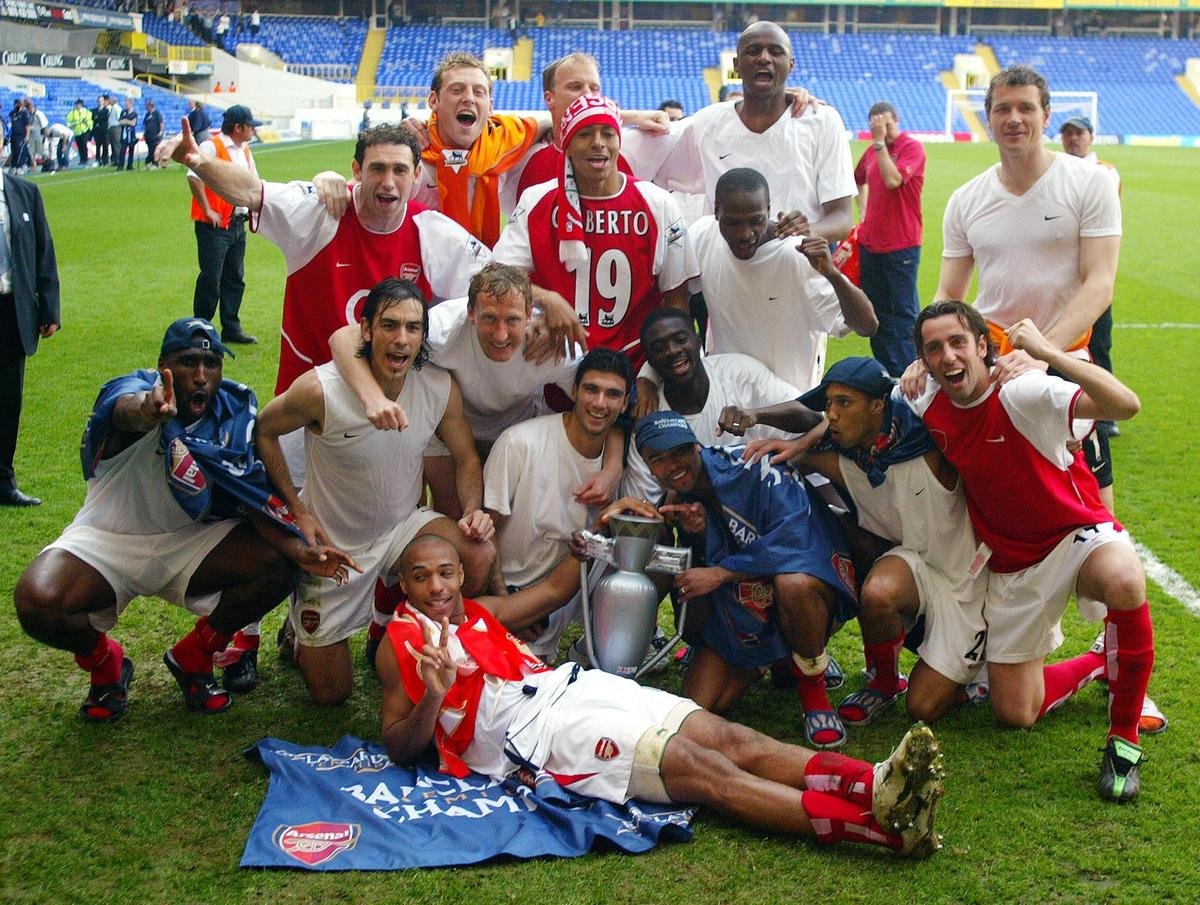 Arsenal players celebrate after winning the Premier League 2003-04 title.