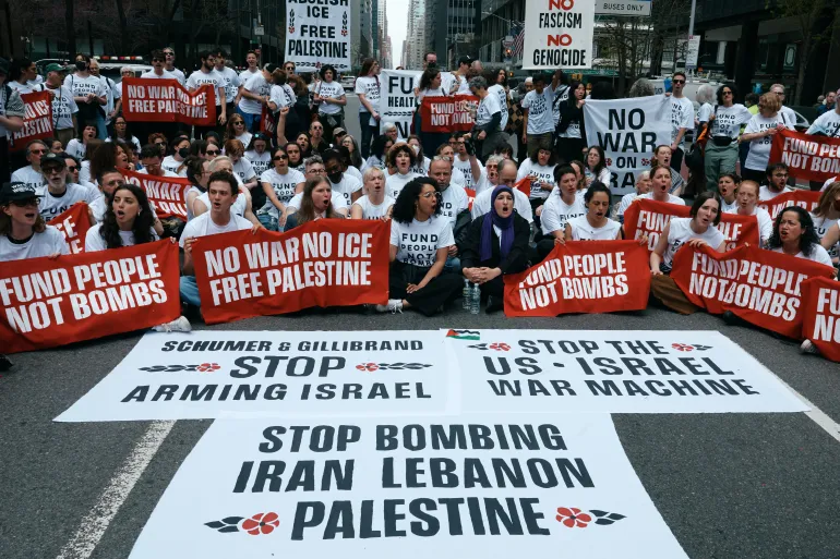 Protesters with Jewish Voice for Peace block traffic during a demonstration outside the New York office of U.S. Sen. Chuck Schumer, calling for an end to the U.S.-Israel war with Iran and opposing U.S. weapons support, Monday, April 13, 2026, in New York.