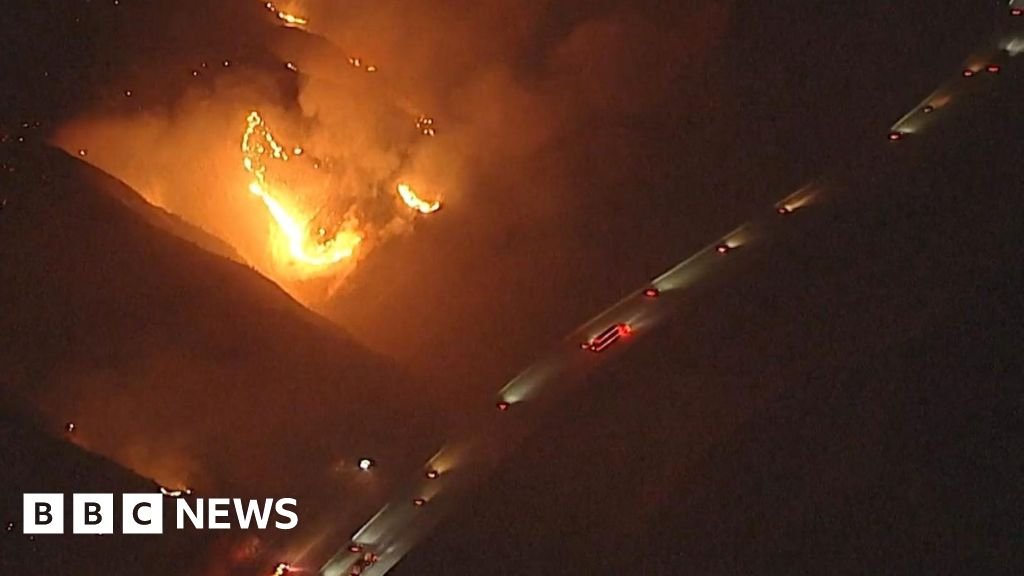 California wildfires burn near passing vehicles