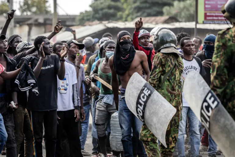 Demonstrators chant slogans as they confront Kenyan police officers during clashes at a demonstration against a controversial US-built Ebola quarantine centre slated to begin operations at Laikipia Air Base in Nanyuki on June 9, 2026. Several Kenyans were arrested on June 9, 2026 in the latest protests against an Ebola quarantine centre being built for US citizens in a tourist town.The centre at Laikipia Air Base in the town of Nanyuki, under the shadow of Mount Kenya, is set to quarantine Americans arriving from the Democratic Republic of Congo (DRC), which is battling a major Ebola outbreak. (Photo by Luis TATO / AFP)