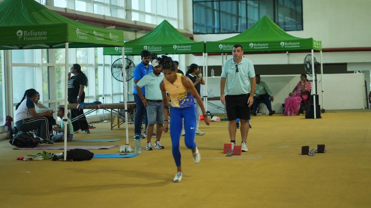 Eyes on the comeback: Coach James Hillier watches as Jyothi Yarraji trains during her return from the ACL injury that sidelined her for over a year.