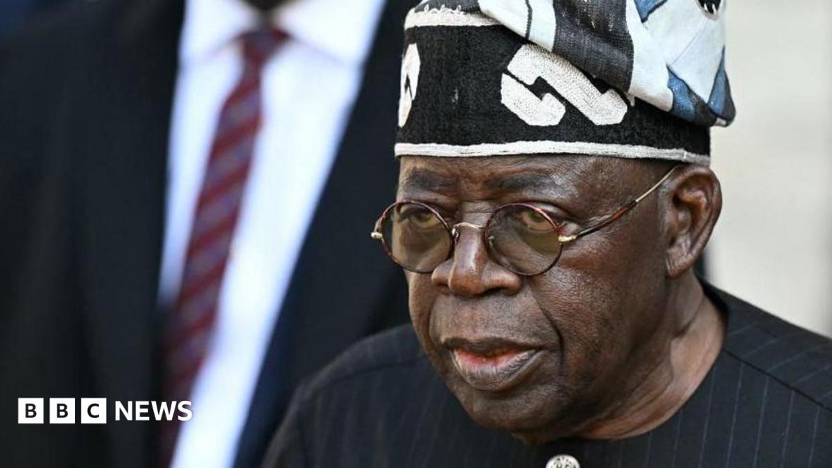 Nigerian leader Bola Tinubu wearing a black gown and hat, as well as glasses
