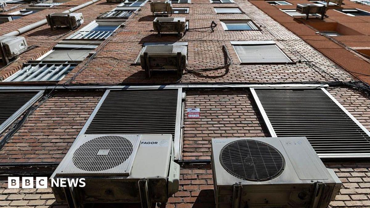 Outdoor air conditioning units are pictured on a building