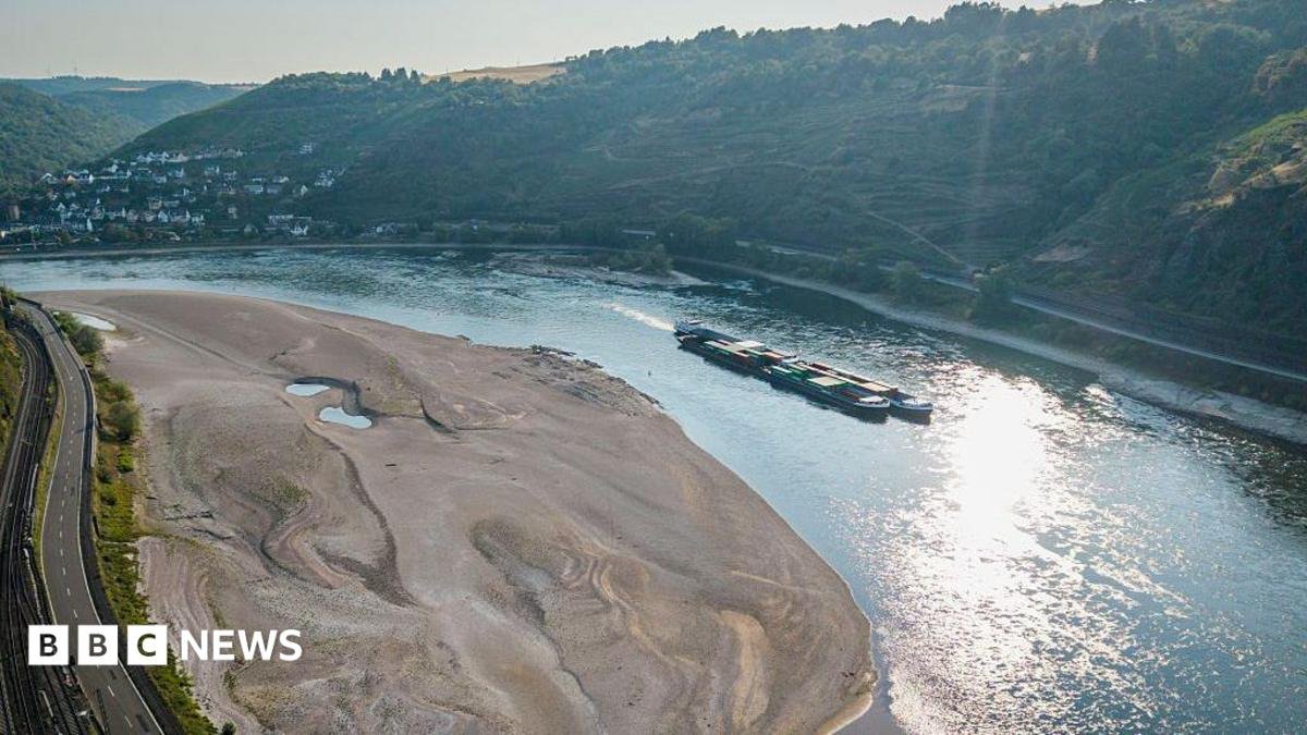 An aerial view as a cargo ship passes a huge exposed sandbar on the Rhine River