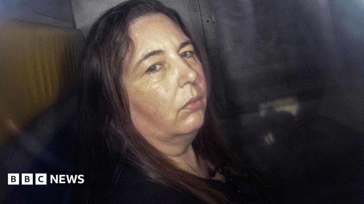 Erin Patterson, looking at the camera in the back of a prison van