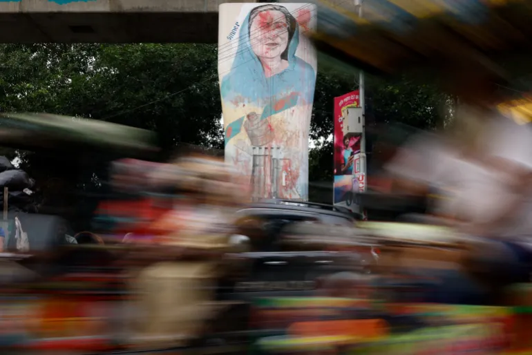 Vehicles move past a mural of Bangladesh’s ousted Prime Minister Sheikh Hasina, at the University of Dhaka, in Dhaka, Bangladesh, June 29, 2026