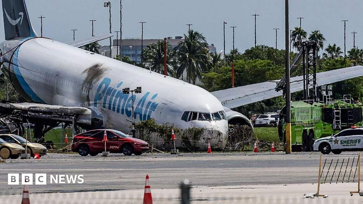 Crews investigate the site of an Amazon cargo plane crash at Miami International Airport on 8 September