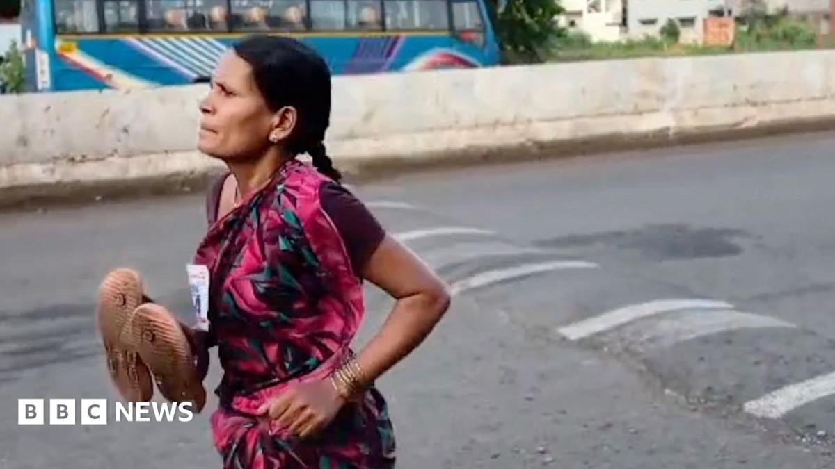 Wearing a long, flowing, colourful, patterned sari and carrying her slippers in her right hand, Ramabai Ranveer, 47, runs along an Indian avenue in the 3km Amrit Daud fun run.