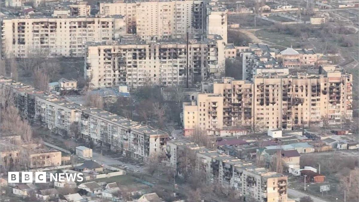 A cityscape showing ruined buildings in a war in Ukraine