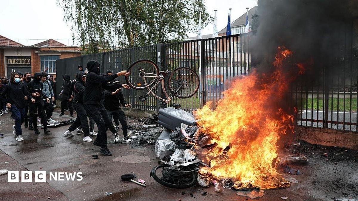 Black smoke billows from burning bins and bicycles as students carry out a blocking protest at the Cesar Baggio secondary school during a day of nationwide public sector strikes and demonstrations, in Lille, on September 29, 2026.