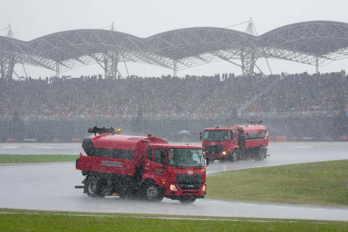 Track sweepers were deployed on the track after heavy rain caused a delay in the Bahrain Grand Prix in Sepang, Malaysia.