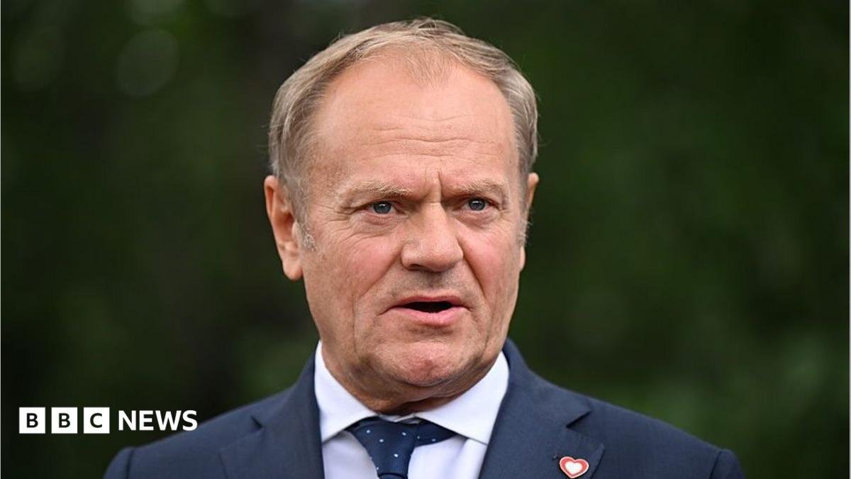 Donald Tusk, who wears a suit and has thinning blonde hair, talks to the press in Tirana, Albania, last year.